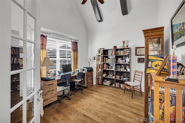 office space with hardwood / wood-style flooring, ceiling fan, and high vaulted ceiling