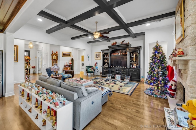 living room with hardwood / wood-style floors, ceiling fan, beamed ceiling, and coffered ceiling