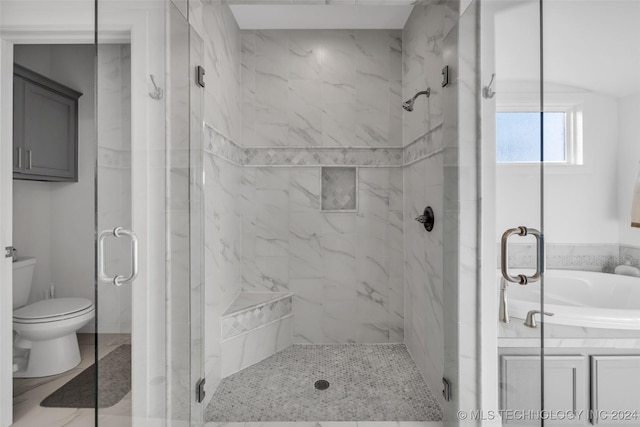 bathroom with shower with separate bathtub and toilet