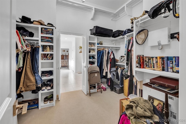 walk in closet featuring light carpet