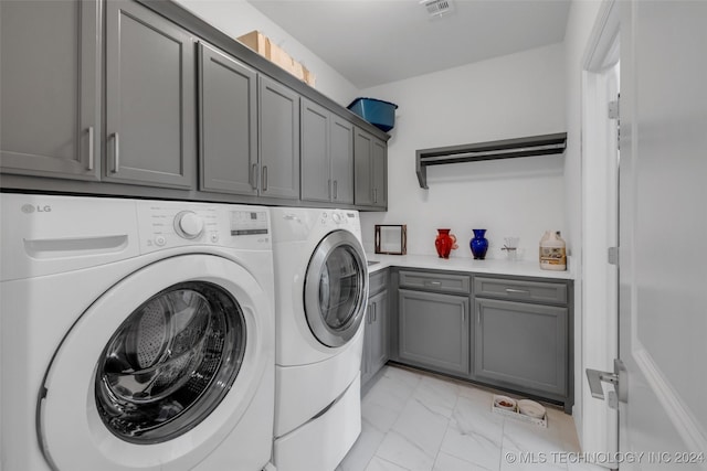 laundry room with cabinets and independent washer and dryer