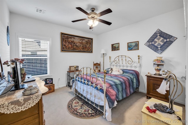 bedroom with light carpet and ceiling fan