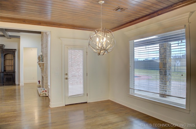 unfurnished dining area with plenty of natural light, hardwood / wood-style floors, a notable chandelier, and wood ceiling