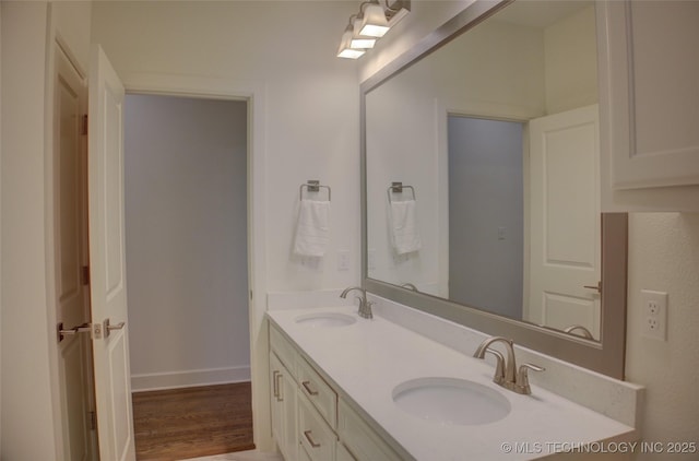 bathroom with vanity and wood-type flooring