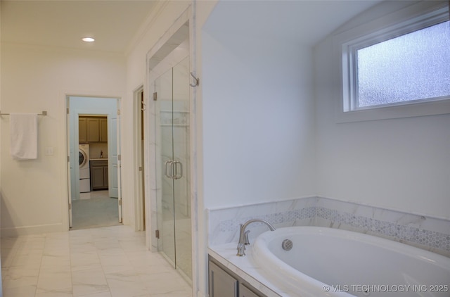 bathroom featuring independent shower and bath and washer / dryer