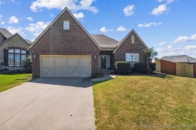 view of front of property with a front yard and a garage