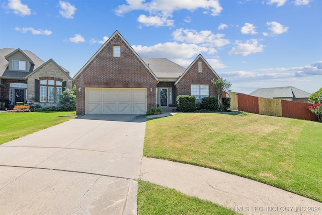 view of front of property with a garage and a front lawn