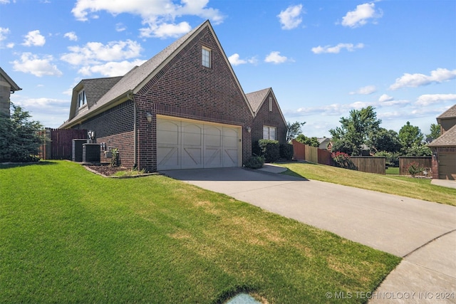 view of side of home featuring a lawn and a garage