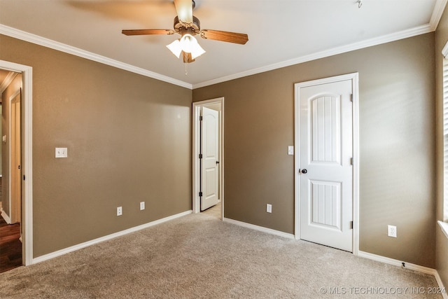 unfurnished bedroom with ceiling fan, light colored carpet, and crown molding