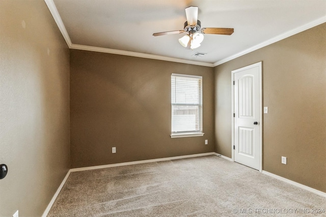 carpeted spare room featuring ceiling fan and ornamental molding