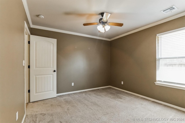 carpeted empty room with ceiling fan and crown molding