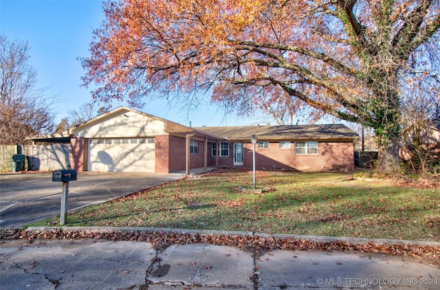 single story home featuring a front lawn and a garage