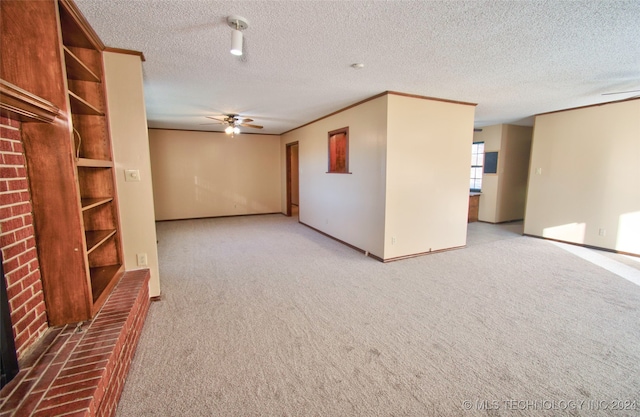 unfurnished living room featuring a textured ceiling, ceiling fan, and light carpet