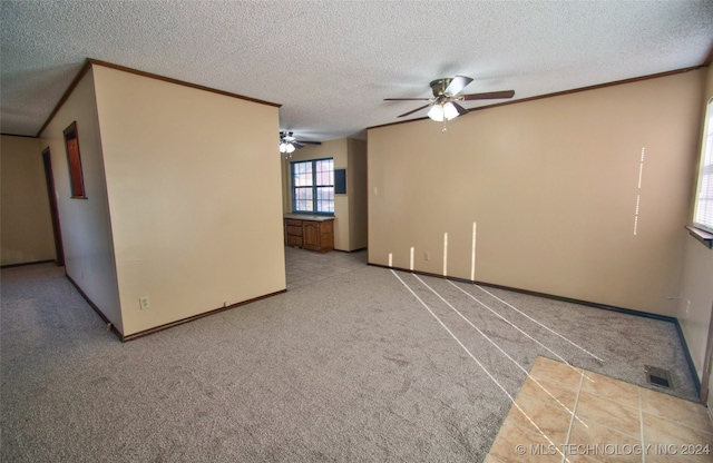 unfurnished room with a textured ceiling, light colored carpet, and ceiling fan