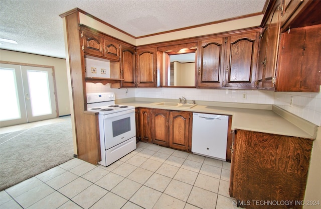 kitchen with white appliances, light carpet, sink, a textured ceiling, and tasteful backsplash