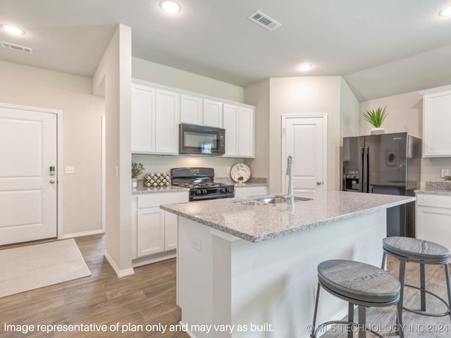 kitchen featuring dark hardwood / wood-style flooring, sink, black appliances, white cabinets, and an island with sink