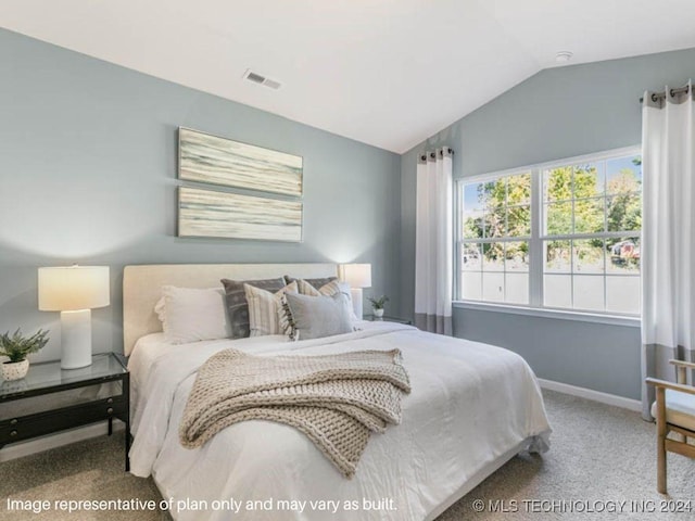 bedroom with carpet and vaulted ceiling