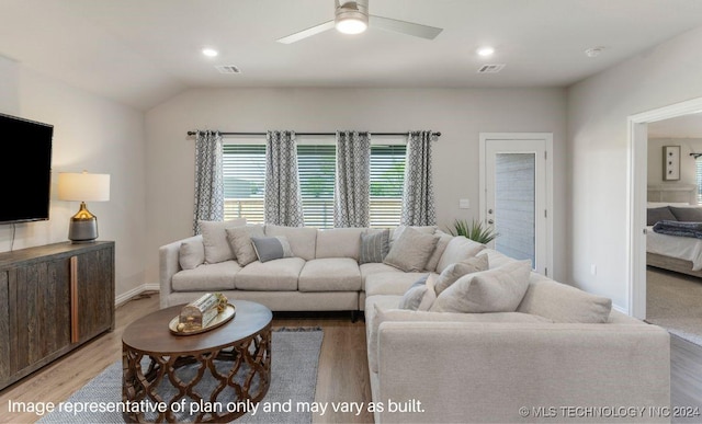 living room featuring ceiling fan, lofted ceiling, and light hardwood / wood-style floors