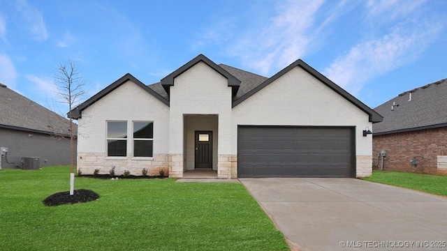 view of front of property with a garage, a front lawn, and central air condition unit