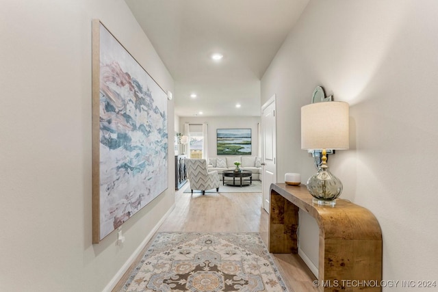 hallway with light hardwood / wood-style flooring