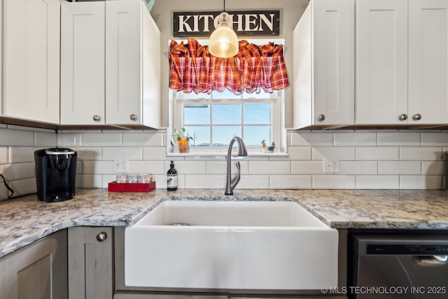 kitchen with white cabinetry, dishwasher, sink, and tasteful backsplash