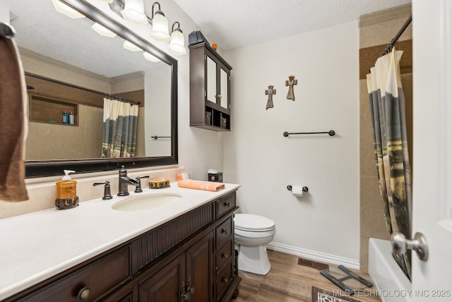 full bathroom featuring hardwood / wood-style floors, vanity, a textured ceiling, toilet, and shower / bath combo with shower curtain