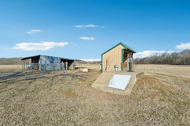 view of storm shelter featuring an outdoor structure and a rural view