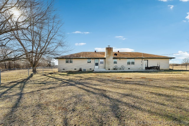 rear view of house with a yard