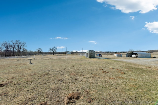 view of yard featuring a shed and a rural view