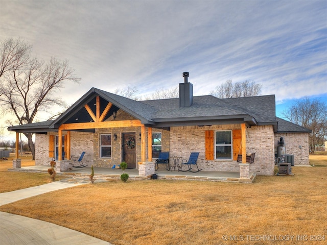 view of front of house featuring a yard and cooling unit