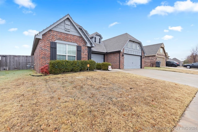 view of front facade with a garage and a front lawn