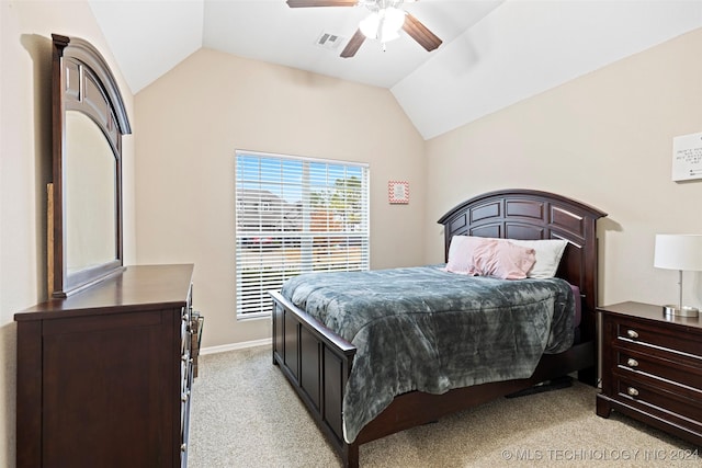 bedroom with ceiling fan, lofted ceiling, and light carpet