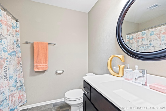 bathroom featuring vanity, hardwood / wood-style flooring, and toilet