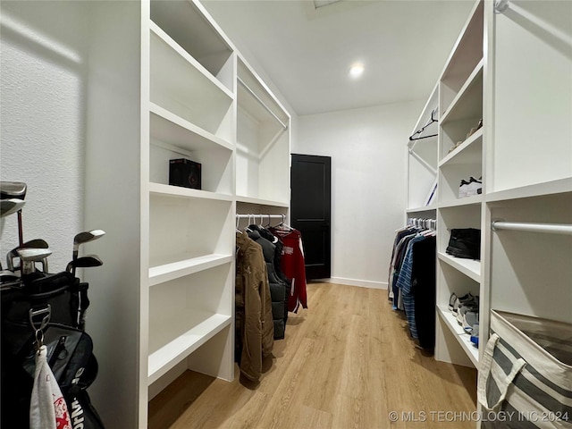 spacious closet with light hardwood / wood-style flooring