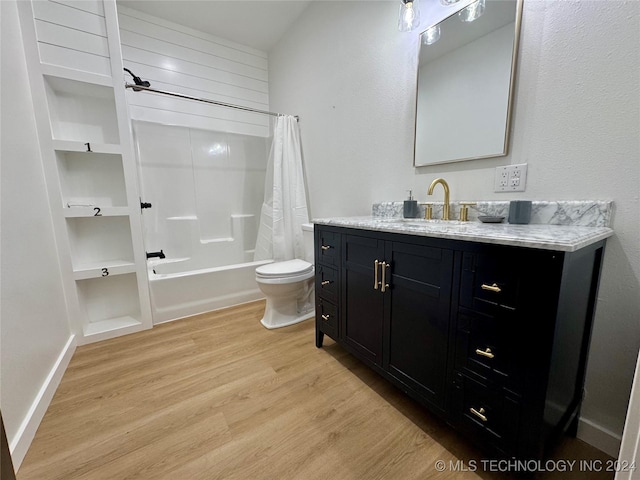 full bathroom with toilet, vanity, shower / bathtub combination with curtain, and hardwood / wood-style floors