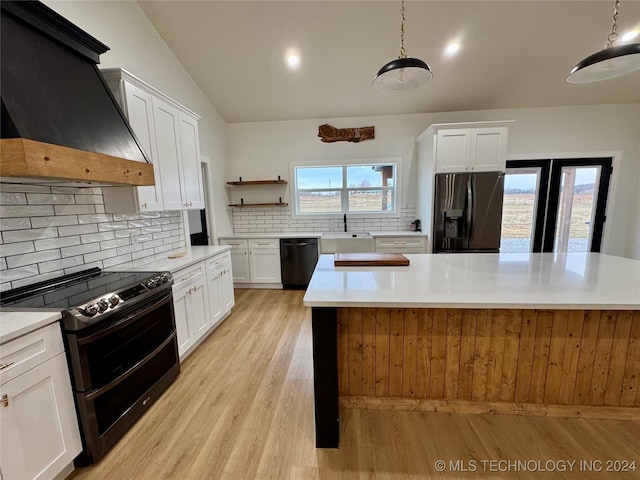 kitchen with decorative light fixtures, stainless steel fridge with ice dispenser, black dishwasher, custom range hood, and range with two ovens