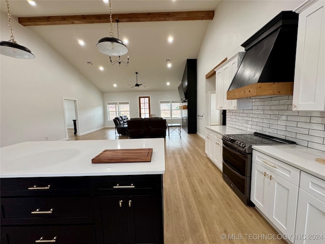 kitchen with premium range hood, white cabinetry, decorative light fixtures, and range with two ovens