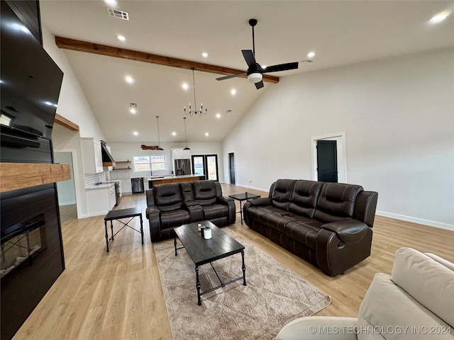 living room with high vaulted ceiling, beam ceiling, light hardwood / wood-style floors, and ceiling fan