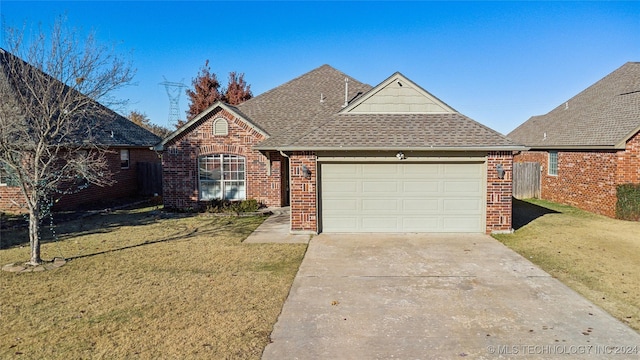 view of front property featuring a garage and a front lawn