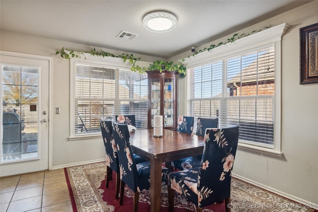 dining room with tile patterned flooring and a wealth of natural light