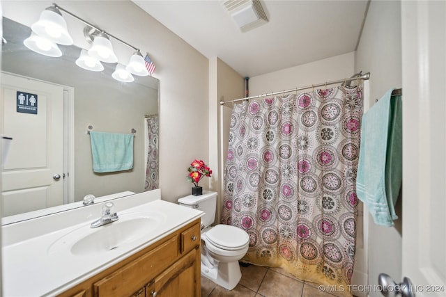 full bathroom featuring tile patterned flooring, vanity, toilet, and shower / bathtub combination with curtain