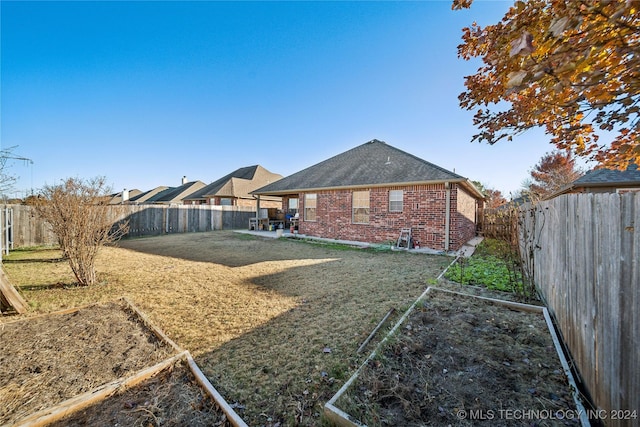 back of property featuring a lawn