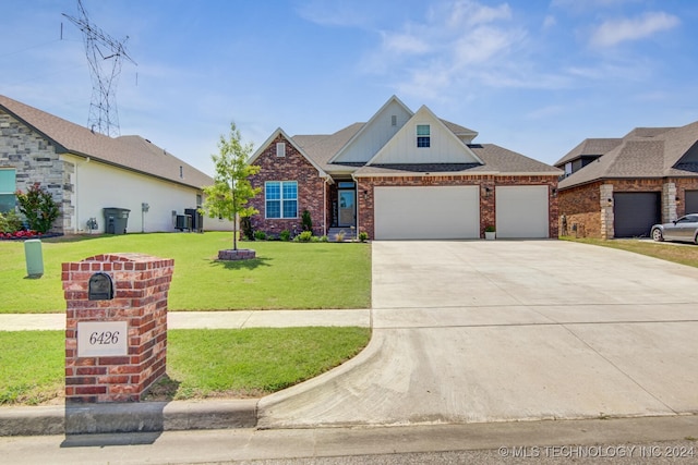 view of front of home with a front yard and a garage