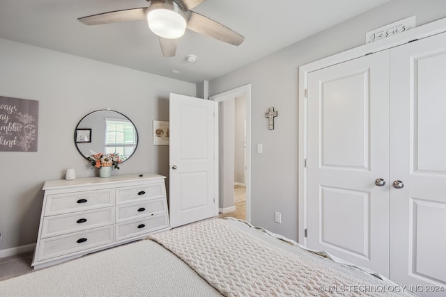 bedroom featuring ceiling fan, a closet, and light carpet