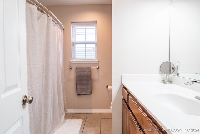 bathroom with tile patterned flooring and vanity