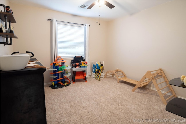 recreation room with carpet floors and ceiling fan