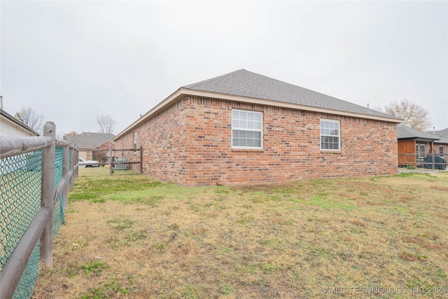 view of side of home featuring a yard