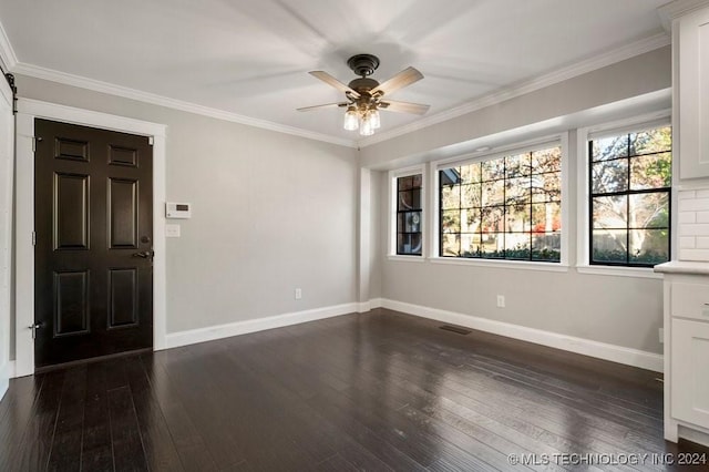 entryway with ceiling fan, crown molding, and dark wood-type flooring