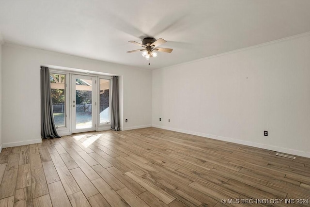 unfurnished room featuring light wood finished floors, crown molding, baseboards, and a ceiling fan