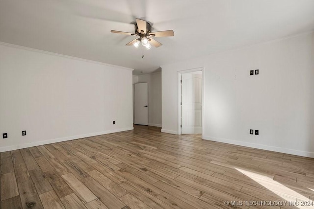 interior space featuring a ceiling fan, crown molding, light wood-style flooring, and baseboards